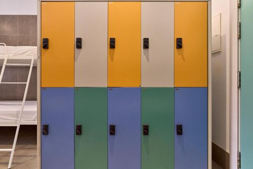 a row of colorful lockers in a room at The Book Factory Hostel by gaiarooms in Valladolid