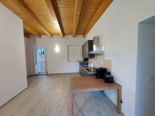 a kitchen with a wooden table in a room at Al Monumento bed & breakfast in Amantea