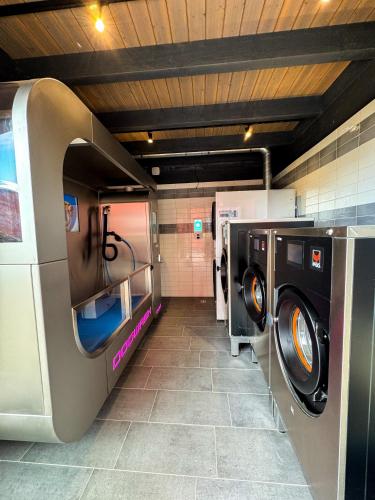 a bathroom with two washing machines in a room at EMSLAND-CAMP in Haar