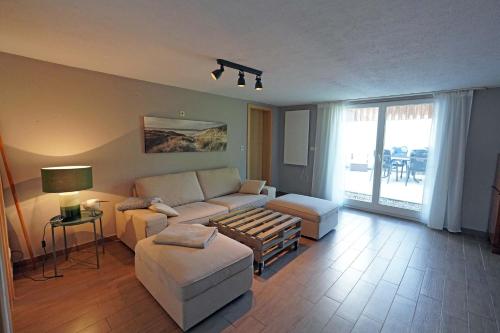 a living room with a couch and a table at Usedomer Landhaus in Kamminke