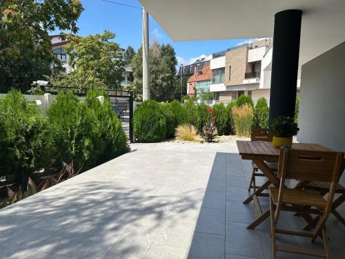 a patio with a table and chairs and a building at EOS - Eforie Nord in Eforie Nord