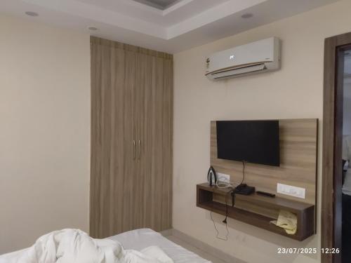 a hotel room with a bed and a television at Hotel Supreme in Gurgaon