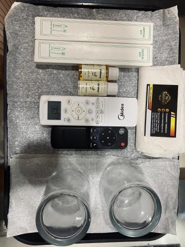 a box with a remote control and some books at The Narendra hotel 700m away from the Ram Mandir in Ayodhya