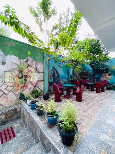 a patio with plants and tables and chairs at TK Homes in Badulla