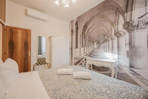 a bedroom with a bed with two towels on it at Santo Stefano Palace in Venice