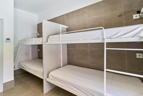 a room with two bunk beds in it at The Book Factory Hostel by gaiarooms in Valladolid