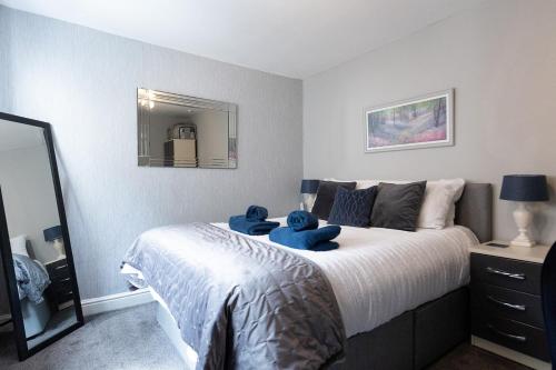 a bedroom with a bed with two teddy bears on it at ORME RISE - Beautiful first floor apartment in Llandudno