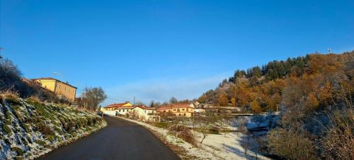 a winding road with houses on the side of a hill at Brkinka Apartments in Vremski Britof