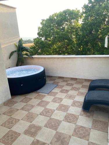 a bathroom with a tub on a balcony with a view at סוד הנחלים in Sede Neẖemya