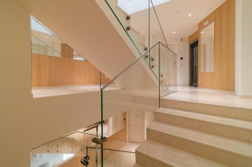 a staircase with glass railings in a house at Palladio13 in San Benedetto del Tronto