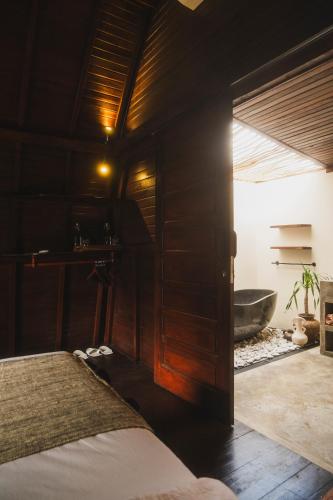 a bedroom with a bed and a bath tub at Savanna Ubud in Ubud