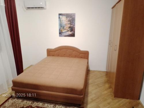 a small bedroom with a bed in a room at Guest House SAM-WATER in Ðenovići