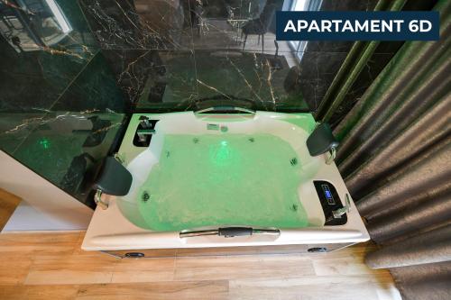 a green bath tub sitting on top of a floor at Słoneczne Wzgórze Zator in Zator