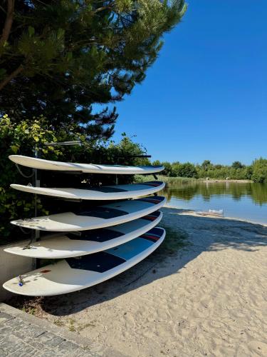 a bunch of surfboards lined up on the beach at EMSLAND-CAMP in Haar