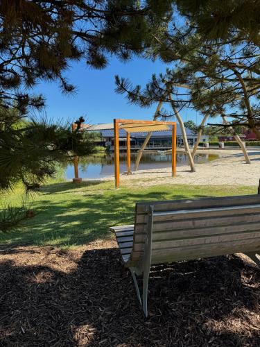 a park bench in a park with a playground at EMSLAND-CAMP in Haar