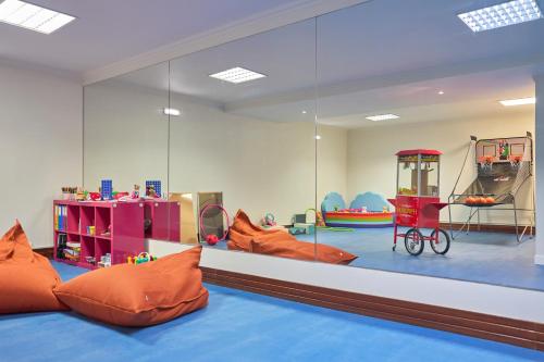 a childrens play room with a large glass wall at PortoBay Blue Ocean in Albufeira