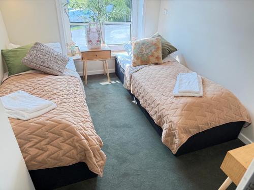 a bedroom with two beds and a window at Bramslev Bakker Naturhotel in Hobro