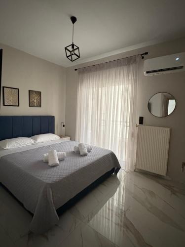 a bedroom with a large bed with towels on it at SeaGlow in Alexandroupoli
