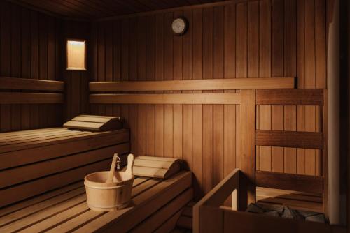 a sauna with two beds and a tub in it at Hotel Genziana in Ortisei