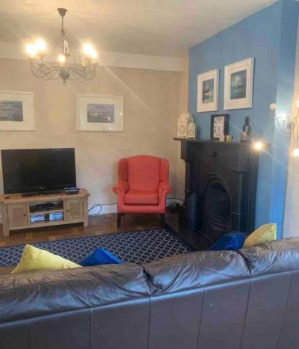 a living room with a couch and a fire place at Enniscrone House in Enniscrone
