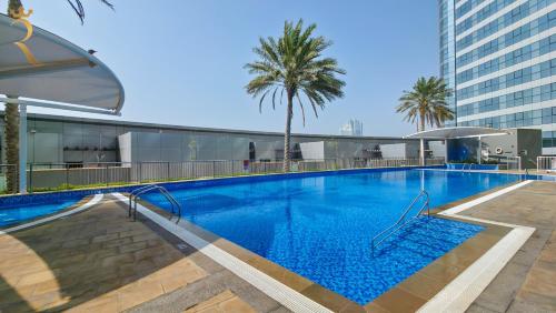 a large swimming pool on top of a building at Azure Marina 1BR - Elegant Chic Haven in Abu Dhabi