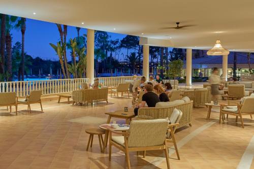 a restaurant with people sitting in chairs and tables at PortoBay Blue Ocean in Albufeira
