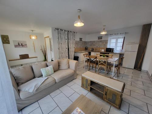 a living room with a couch and a table at La marine D'opale in Ambleteuse