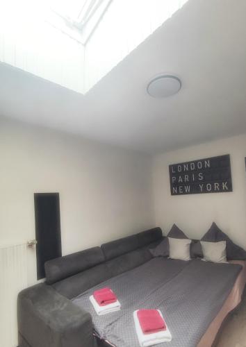 a bedroom with a bed with pink and white pillows at Mosel Boutique in Bruttig-Fankel