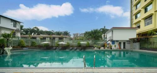 a large swimming pool in front of a building at Home2 Suite by Hilton Xishuangbanna Jinghong in Jinghong