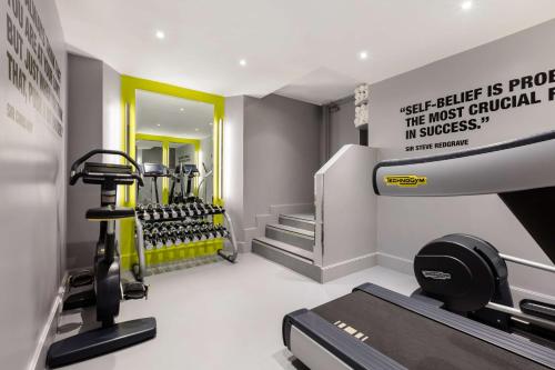 a fitness room with a gym with a treadmill at Radisson Blu Hotel, London Marble Arch in London
