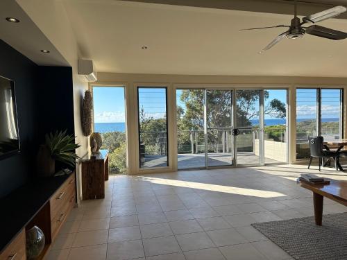 a living room with a view of the ocean at Pikes Point Beach House in Merimbula