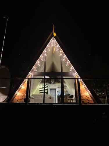a house with lights on the roof at night at Greenkova in Kamenitsa