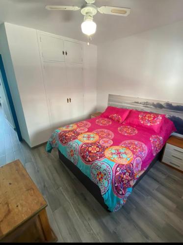 a bedroom with a large bed with a pink blanket at Stunning Apartment in the heart of Mijas Pueblo in Mijas