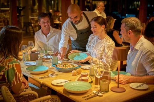 a group of people sitting around a table at PortoBay Blue Ocean in Albufeira