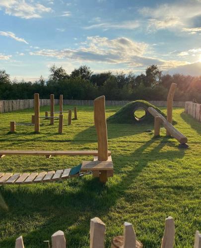 a group of wooden benches in a field at EMSLAND-CAMP in Haar