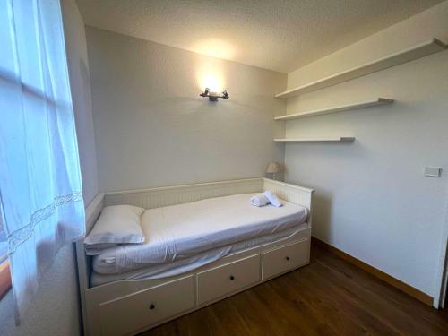 Cette petite chambre comprend un lit avec une lumière sur le mur. dans l'établissement Planta baja con piscina en Caldegas, à Bourg-Madame