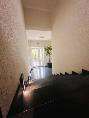 an empty room with a hallway with a door at Neva Apartments & Rooms in Făgăraş