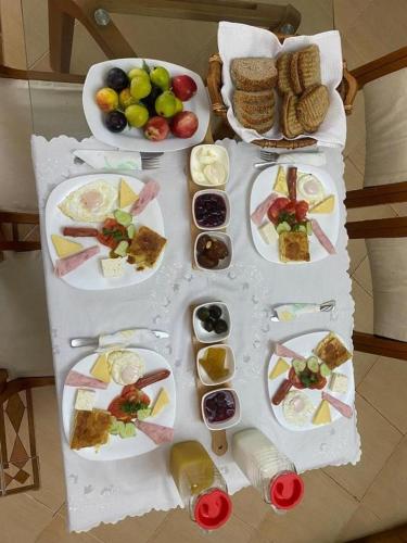 a table with several plates of food on it at Sava's House in Berat