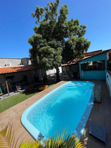 a large blue swimming pool next to a house at Nosso Quintal in Santo Amaro