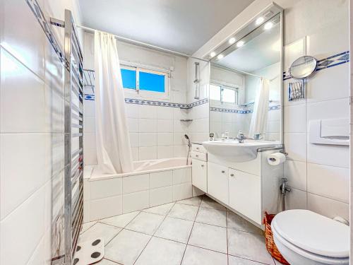 un bagno bianco con un water e un lavandino di Grand bleu Front de Mer Magnifique 3 Pièces garage a Antibes