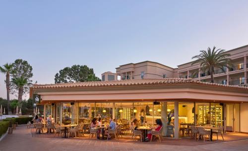 people sitting at tables outside of a restaurant at PortoBay Blue Ocean in Albufeira