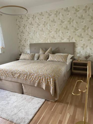 a bedroom with a large bed and a rug at Neue Ferienwohnung mit Terrasse in Guteborn