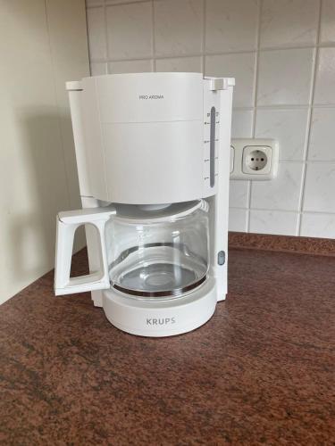 a white coffee maker sitting on a counter at Neue Ferienwohnung mit Terrasse in Guteborn