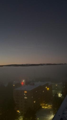 a view of a city in the water at night at Panoramic View Harz in Altenau