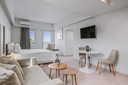 a hotel room with a bed and a couch at Almyra Resort in Koutsounari