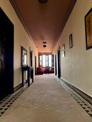 a hallway of a building with couches and a window at Villa Marrakchia - Palais d'hôtes & spa in Marrakech