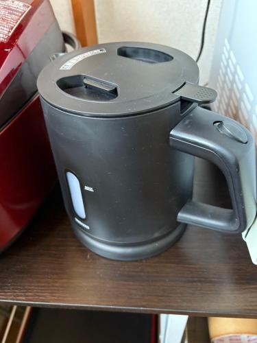 a slow cooker sitting on top of a shelf at Nikko-Imaichi "The LINKs" Dormitory House in Nikko