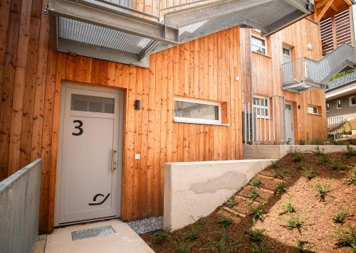 a building with a door with the number three at OpenSky Wörthersee Lodge in Pörtschach am Wörthersee