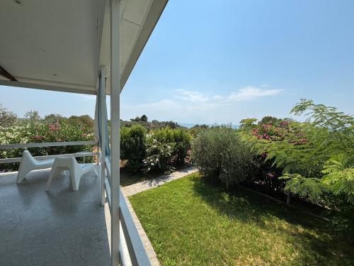 a view of a balcony with a white bench at Modern Summer House Popi in Pálioura