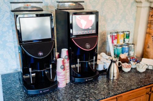 two coffee machines sitting on top of a counter at Lilleshall House & Gardens and Lilleshall National Sports Centre in Telford